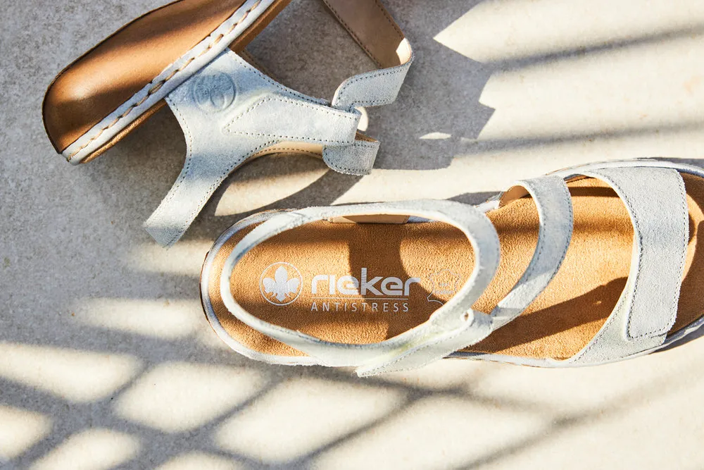 a pair of Rieker sandals on a concrete surface
